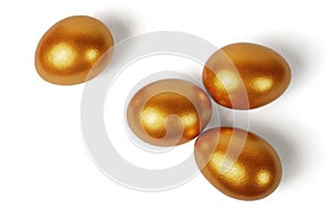 Four Easter golden eggs on a white background