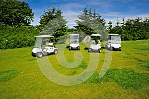 Four eco transporters on golf course