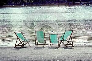 four empty deck chairs at the Hyde Park in London