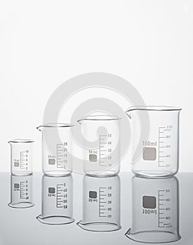 Four empty measuring beakers