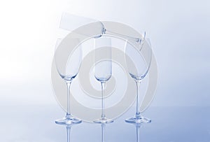 Four empty wine glass on a light blue background