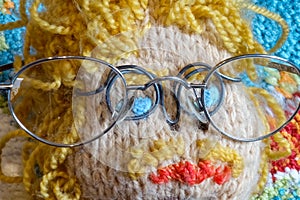 Four eyes motto picture. Male doll with glasses, blue eyes, blond hair and mustache. spectacled snake icon image. Stereotypical
