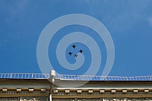 Four F-16 Fighting Falcon NATO military aircrafts from Poland are flying in blue sky over Kyiv