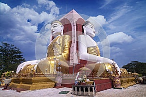 Four faces of Buddha statue, at Kyaikpun Pagoda in Bago, Myanmar