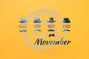 Four faces with mustaches for Movember on yellow orange