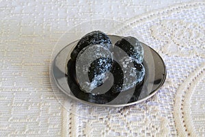 Four figs, crystallized arranged in a plate