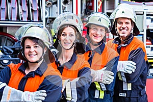 Four fire fighters doing thumbs up