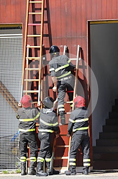 four firefighters in action during the exercise in the fire stat
