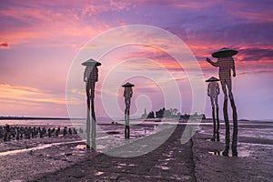 Four fishermen sculptures at low tide in kinmen