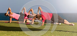 Four fit young women doing pilate exercises against fitness interface