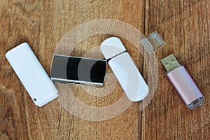 Four flash drives on a wooden table.