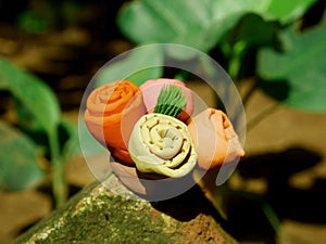 Four flower group with green leaf on center created with soft clay colorful soil material