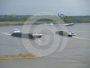 Four freight ships meeting in a bench of the river Rhine