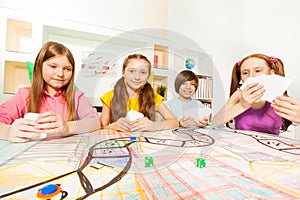 Four friends playing card game at the gaming table