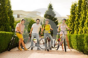 Four friends resting with bicycles.