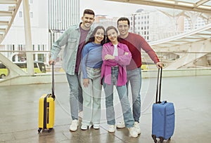 Four Friends Standing With Travel Suitcases In Modern Airport Indoor