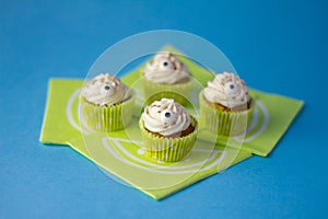 Four funny cream cupcakes with two little eyes