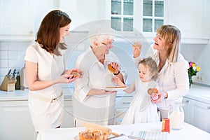 Four generations of women baking apple pie