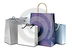 Four gift colored paper bags on white background. Close up