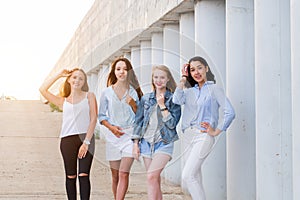 Four girlfriends looking at camera together. people, lifestyle, friendship, vocation concept