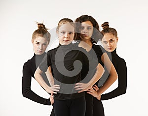 Four girls of different ages in dance poses and black clothes