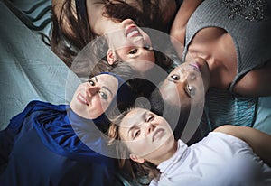 Four girls of different nationalities lying, studio shot