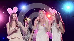 Four girls having fun at bachelorette party blowing soap bubbles