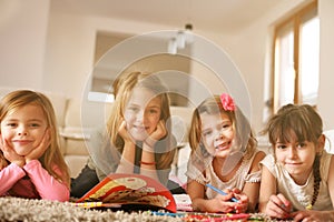 Four girls lying on the floor.