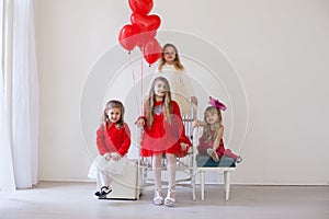 Four girls in red and white clothes with balloons