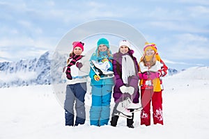Four girls together with ice skates
