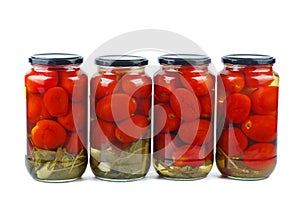 Four glass jare with tomatoes isolated on a white