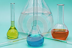 Four glass laboratory flasks with solutions of various colors. The concept of medical and chemical experiments. Laboratory and