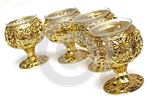 Four plastic golden colored table cup candle holders