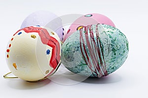 Four hand-painted Easter eggs on white background