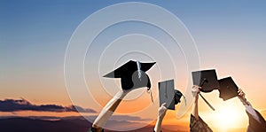 Four hands holding graduation hats photo