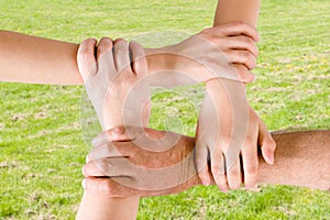 Four hands joined together
