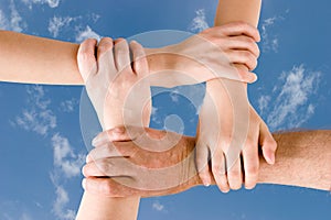 Four hands joined together