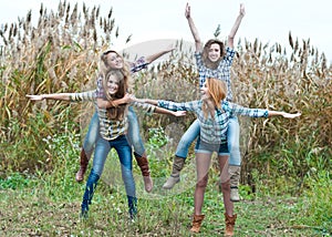 Four happy teen girls friends having fun outdoors