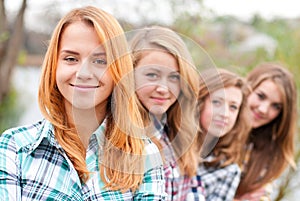 Four happy teenage friends outdoors