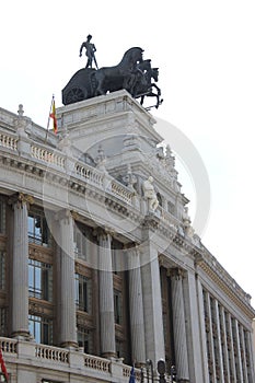 Four horse chariot sculpture on top of Banco Bilbao Vizcaya building in Madrid, Spain. Vertical shot