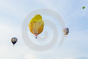 Four hot air balloons in blue sky