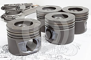 Four identical pistons on white background. spare internal combustion engine