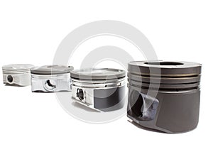 Four identical pistons on white background. spare internal combustion engine