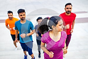 four indian people warming up outdoors in sport wear morning time urban photo