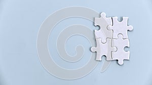 Four Jigsaw Puzzle Pieces Interlocking: Symbolizing Teamwork and Collaboration