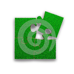 Four jigsaw puzzles with green grass, 3D illustration