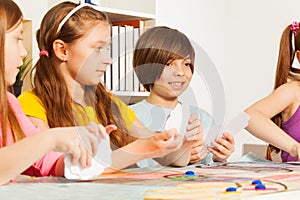 Four kids playing cards for a pastime