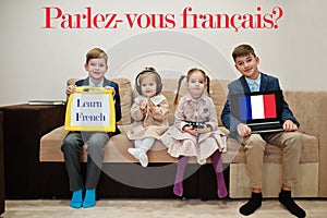 Four kids show inscription learn french. Foreign language learning concept. Parlez vous francais