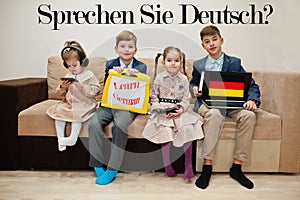 Four kids show inscription learn german. Foreign language learning concept. Sprechen sie Deutsch