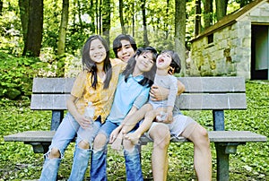 Four kids sitting on bench